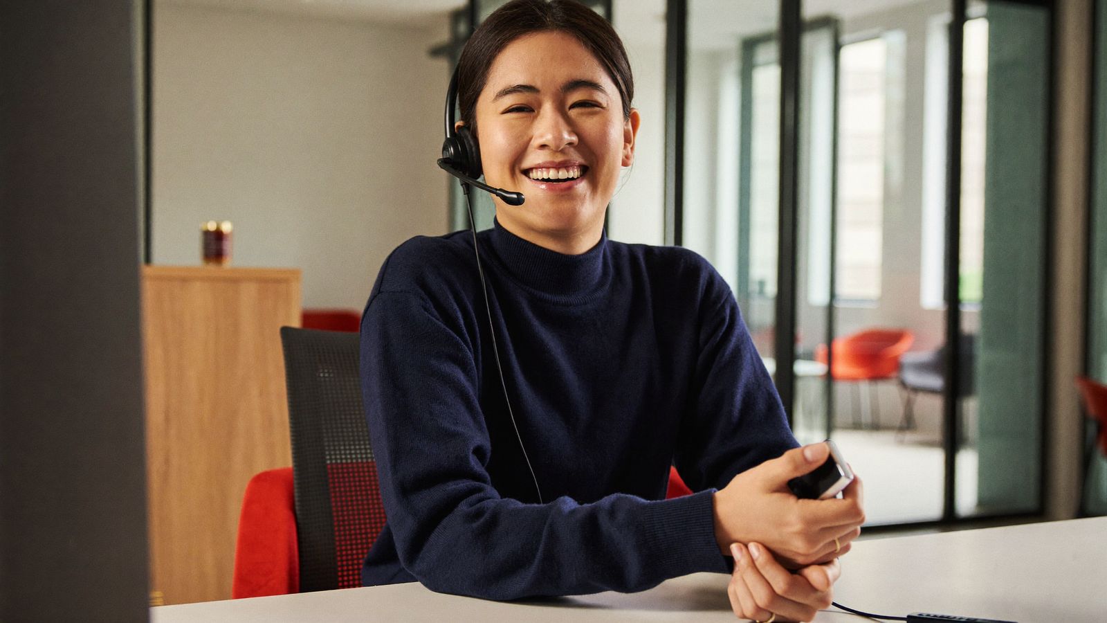 A Vexabit client services specialist taking a call at the office