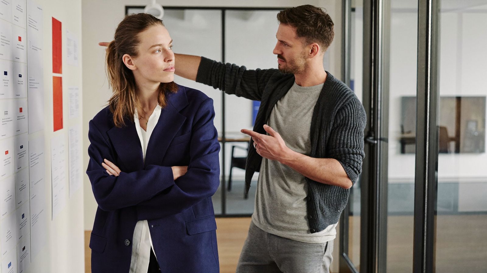 A Vexabit designer and developer reviewing interface layouts on the studio wall
